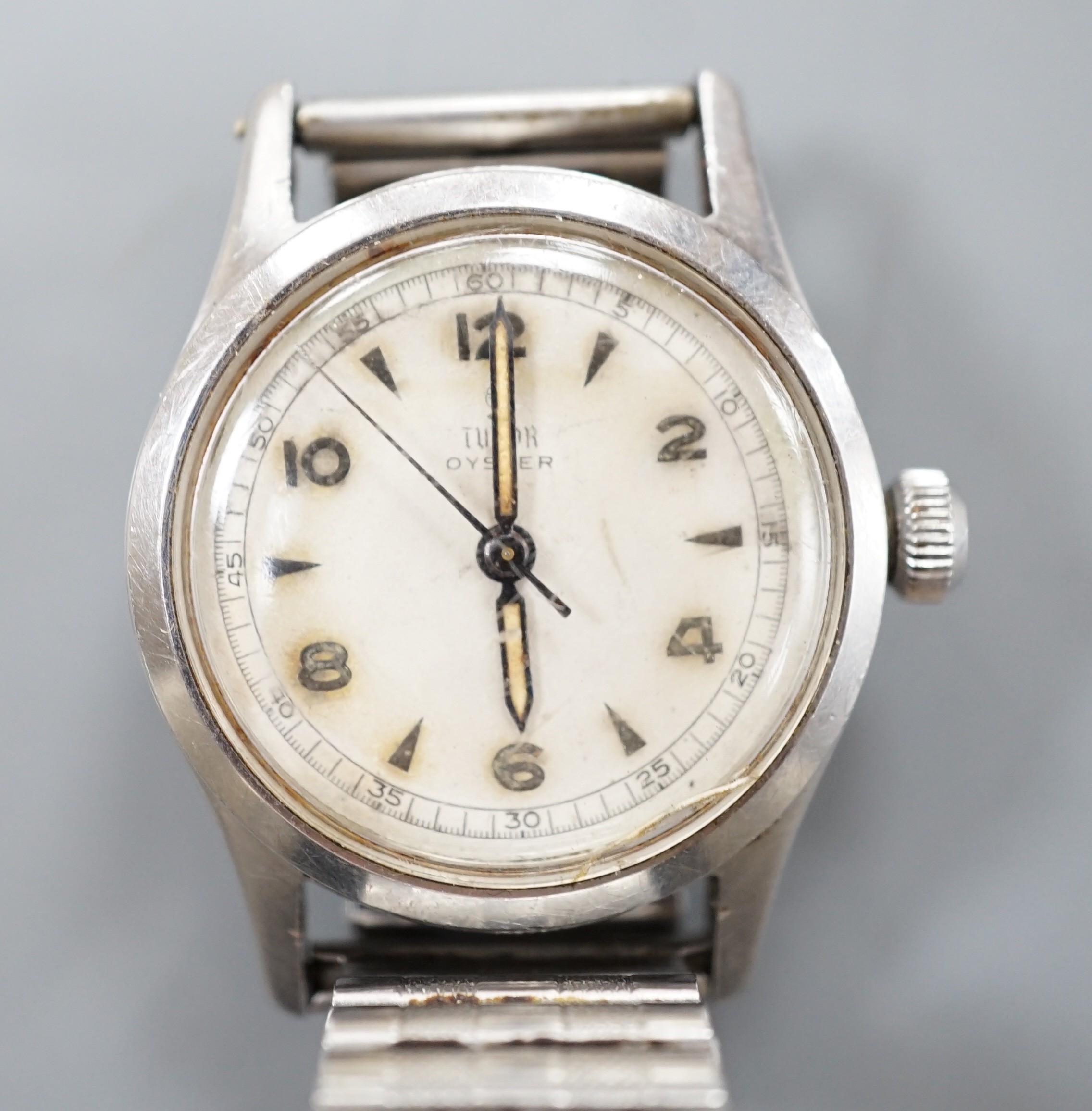 A gentleman's stainless steel Tudor Oyster manual wind wrist watch, with baton and Arabic numerals, on associated flexible bracelet, case diameter 32mm, case back numbered 449386.